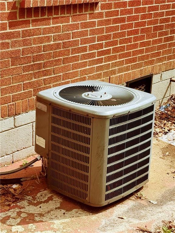 details with central AC unit and brick siding