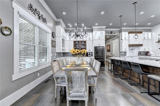 dining room with a notable chandelier, ornamental molding, and a wealth of natural light