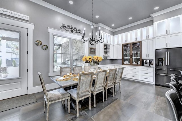 dining area with dark tile flooring and an inviting chandelier