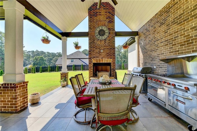 view of patio / terrace featuring a grill, area for grilling, and a fireplace