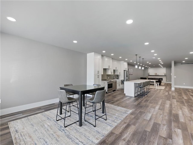 dining area featuring sink and hardwood / wood-style floors