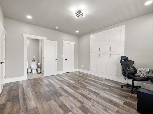 unfurnished office with dark hardwood / wood-style floors