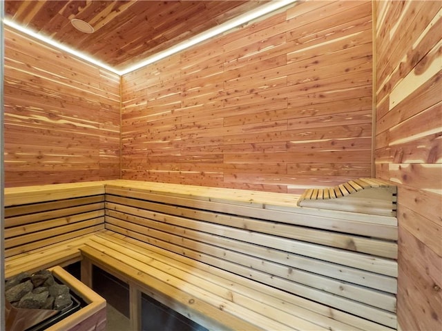 view of sauna / steam room with wooden walls and wood ceiling