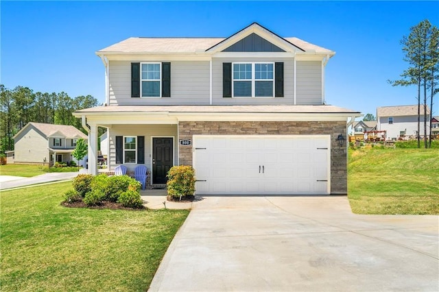 view of front of home featuring a front lawn, a porch, and a garage