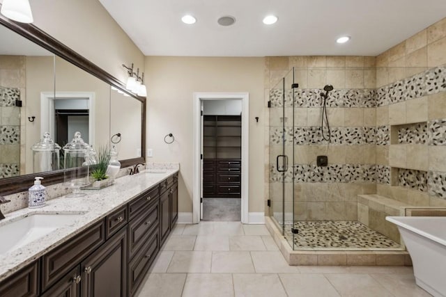 bathroom with tile patterned floors, vanity, and independent shower and bath