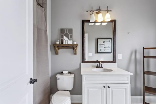 bathroom featuring vanity, curtained shower, and toilet