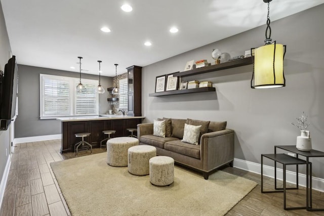 living room featuring indoor bar and hardwood / wood-style floors