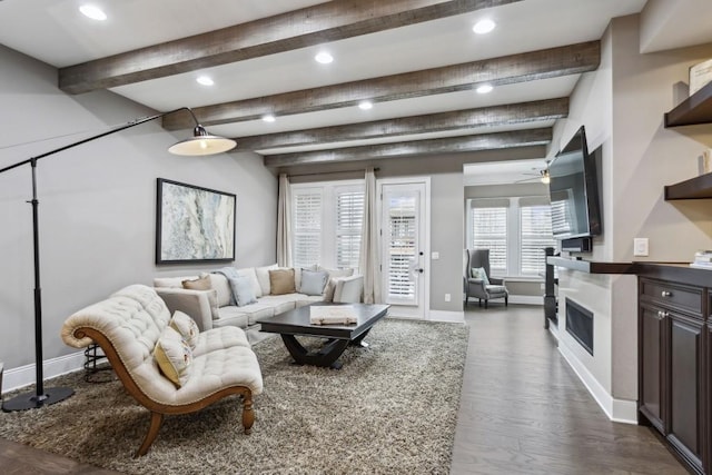 living room with ceiling fan, dark hardwood / wood-style flooring, and beam ceiling