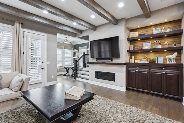 living room with beam ceiling, dark hardwood / wood-style floors, and ceiling fan