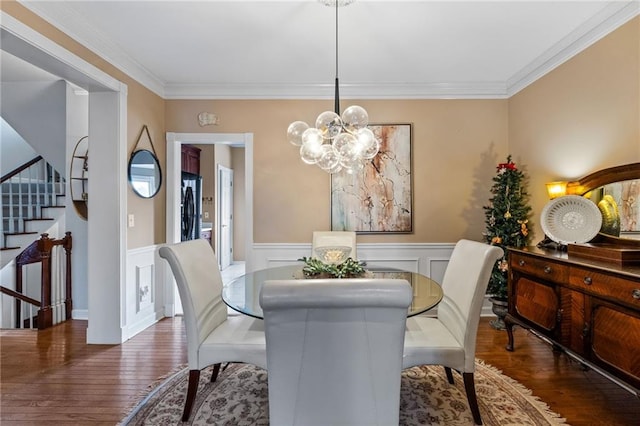 dining area with an inviting chandelier, dark hardwood / wood-style floors, and crown molding