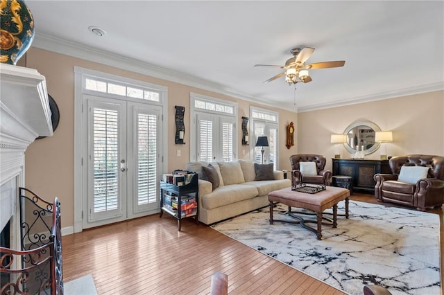 living room with hardwood / wood-style flooring, crown molding, ceiling fan, and french doors