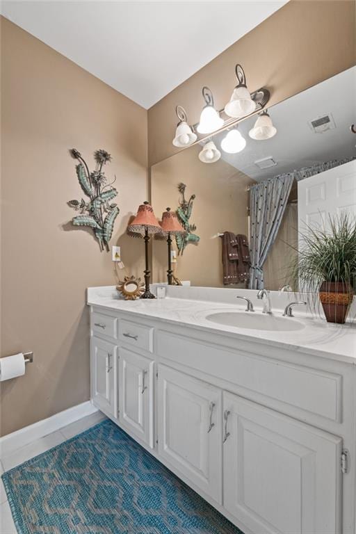 bathroom featuring tile patterned flooring and vanity