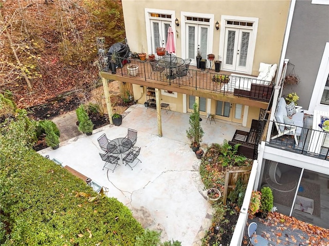 view of patio with french doors and a balcony