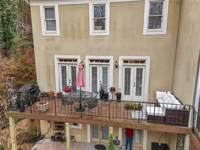 back of property with a patio area and french doors