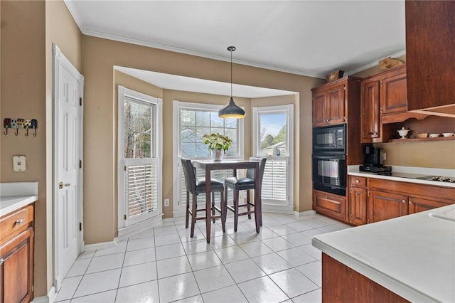 kitchen with ornamental molding, decorative light fixtures, black microwave, and light tile patterned floors