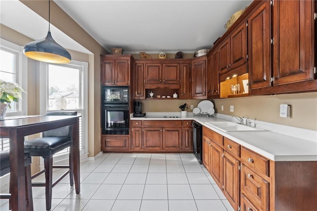 kitchen with sink, crown molding, light tile patterned floors, pendant lighting, and black appliances