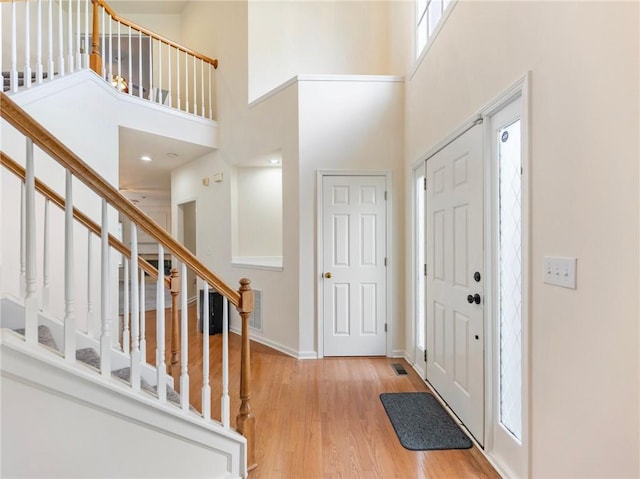 3515 Mcclure Woods Dr, Duluth, GA 30096 - entrance foyer with a high ceiling, stairs, and light wood-style floors