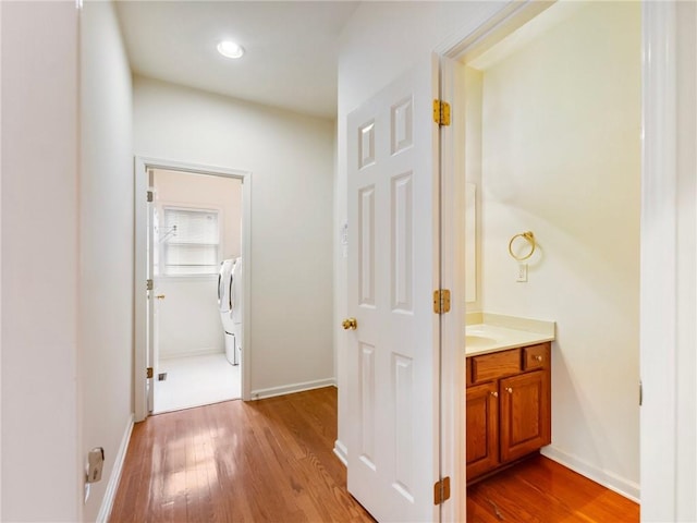 3515 Mcclure Woods Dr, Duluth, GA 30096 - bathroom featuring wood finished floors, vanity, washing machine and clothes dryer, and recessed lighting