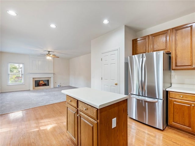 3515 Mcclure Woods Dr, Duluth, GA 30096 - kitchen with freestanding refrigerator, brown cabinetry, a ceiling fan, light wood-style floors, and recessed lighting