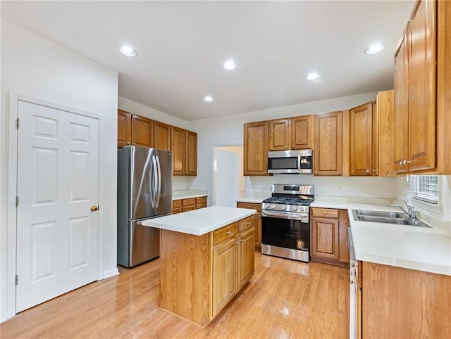 3515 Mcclure Woods Dr, Duluth, GA 30096 - kitchen with appliances with stainless steel finishes, a kitchen island, light wood finished floors, light countertops, and recessed lighting