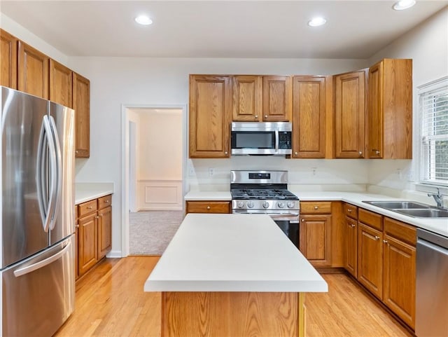 3515 Mcclure Woods Dr, Duluth, GA 30096 - kitchen featuring stainless steel appliances, brown cabinetry, light wood finished floors, light countertops, and recessed lighting