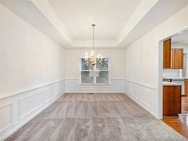 3515 Mcclure Woods Dr, Duluth, GA 30096 - unfurnished dining area featuring a chandelier, a decorative wall, a tray ceiling, and a wainscoted wall