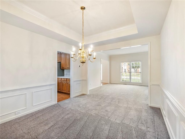 3515 Mcclure Woods Dr, Duluth, GA 30096 - empty room with a chandelier, a decorative wall, light colored carpet, a raised ceiling, and a wainscoted wall