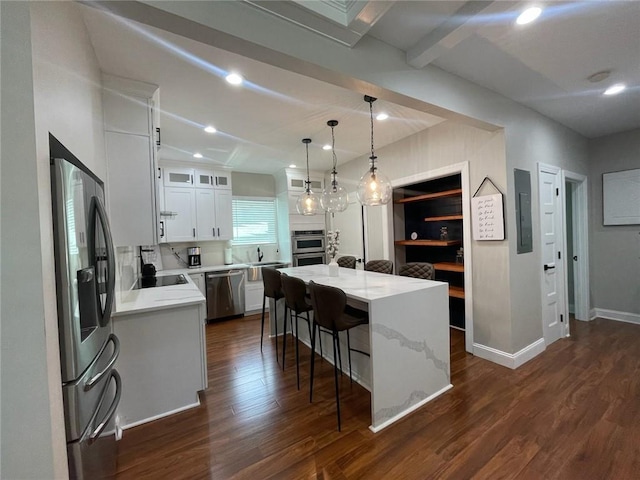 kitchen featuring a center island, appliances with stainless steel finishes, dark hardwood / wood-style flooring, pendant lighting, and white cabinets