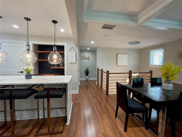 dining room featuring ornamental molding, hardwood / wood-style floors, and beam ceiling