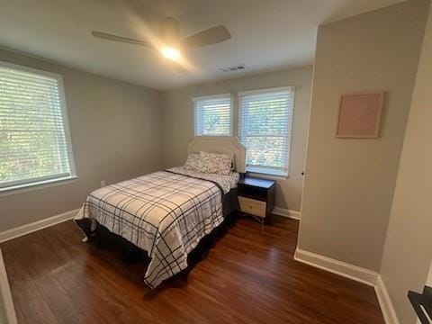 bedroom with dark wood-type flooring and ceiling fan