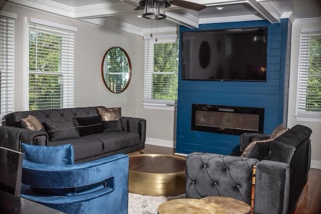 living room featuring coffered ceiling, ornamental molding, dark hardwood / wood-style floors, ceiling fan, and a fireplace