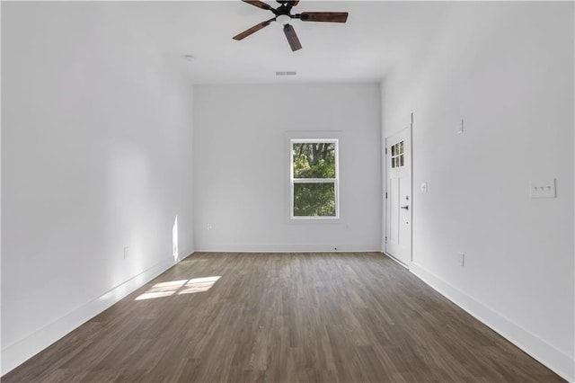 empty room featuring ceiling fan and dark hardwood / wood-style flooring