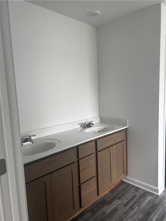 280 River Run Dr, Dallas, GA 30132 - bathroom featuring double vanity, wood finished floors, and baseboards