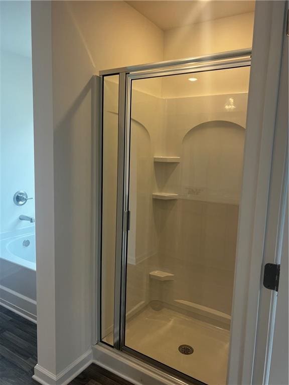 280 River Run Dr, Dallas, GA 30132 - full bath featuring a stall shower, wood finished floors, and a bath