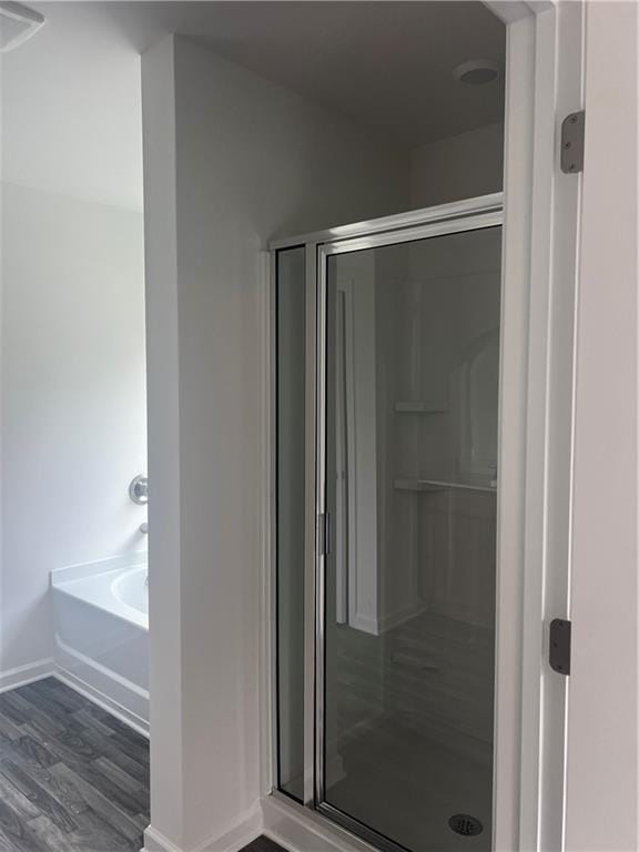 280 River Run Dr, Dallas, GA 30132 - bathroom featuring baseboards, a shower stall, wood finished floors, and a garden tub