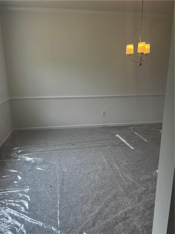280 River Run Dr, Dallas, GA 30132 - spare room with a chandelier, ornamental molding, and baseboards