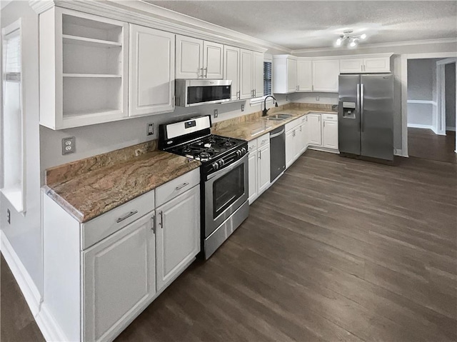 kitchen featuring stainless steel appliances, white cabinetry, and dark wood-type flooring