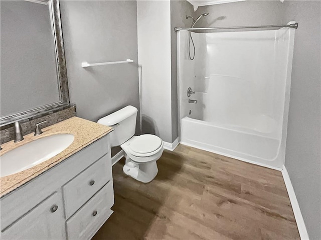 full bathroom featuring vanity, toilet, wood-type flooring, and washtub / shower combination