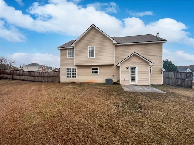 back of property with a yard, a patio, and central air condition unit