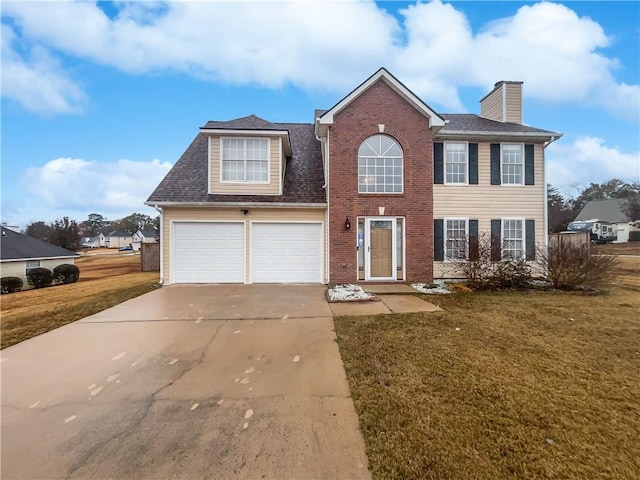 view of front of home featuring a garage and a front lawn