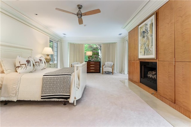 bedroom featuring light carpet, ceiling fan, and crown molding