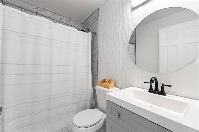 full bathroom featuring vanity, tile walls, and toilet