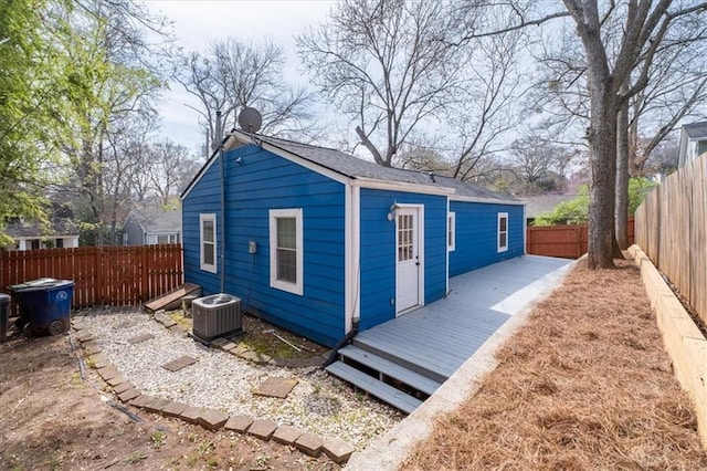 view of outdoor structure with central air condition unit and a fenced backyard