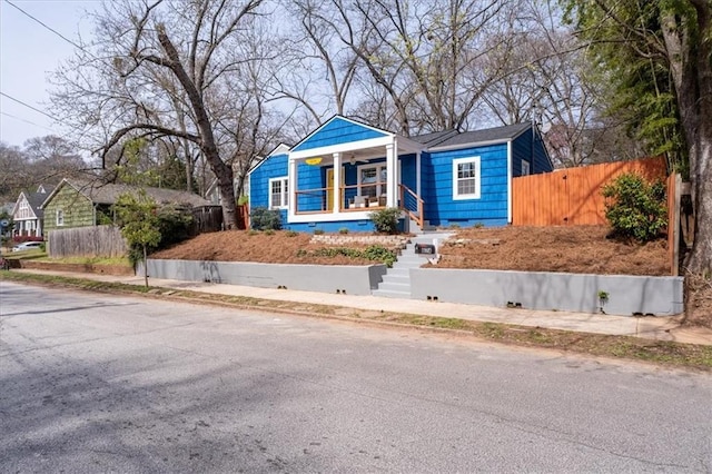 bungalow with fence and covered porch