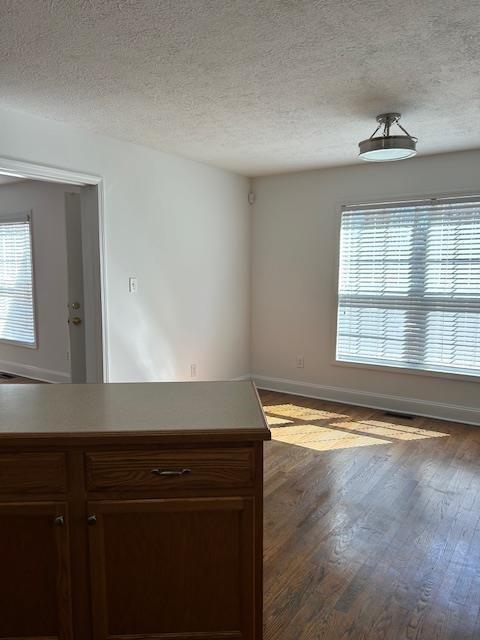 unfurnished room featuring a textured ceiling and hardwood / wood-style flooring