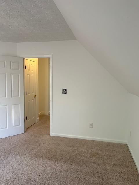 bonus room featuring ceiling fan, carpet floors, and vaulted ceiling