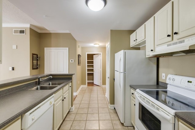 kitchen with visible vents, a sink, under cabinet range hood, white appliances, and light tile patterned floors