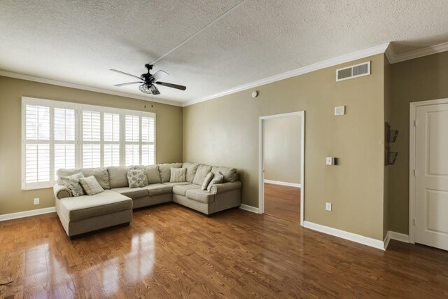 unfurnished living room featuring ornamental molding, a ceiling fan, a textured ceiling, wood finished floors, and baseboards