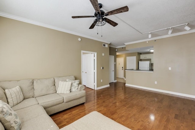 living room with visible vents, crown molding, ceiling fan, baseboards, and wood finished floors