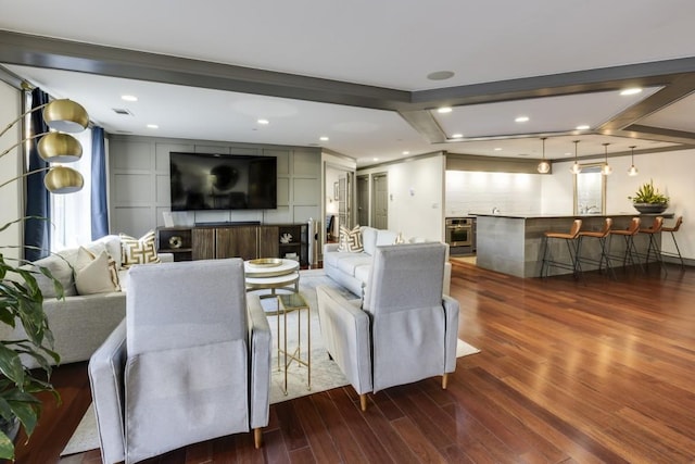 living room with recessed lighting, beamed ceiling, visible vents, and wood finished floors